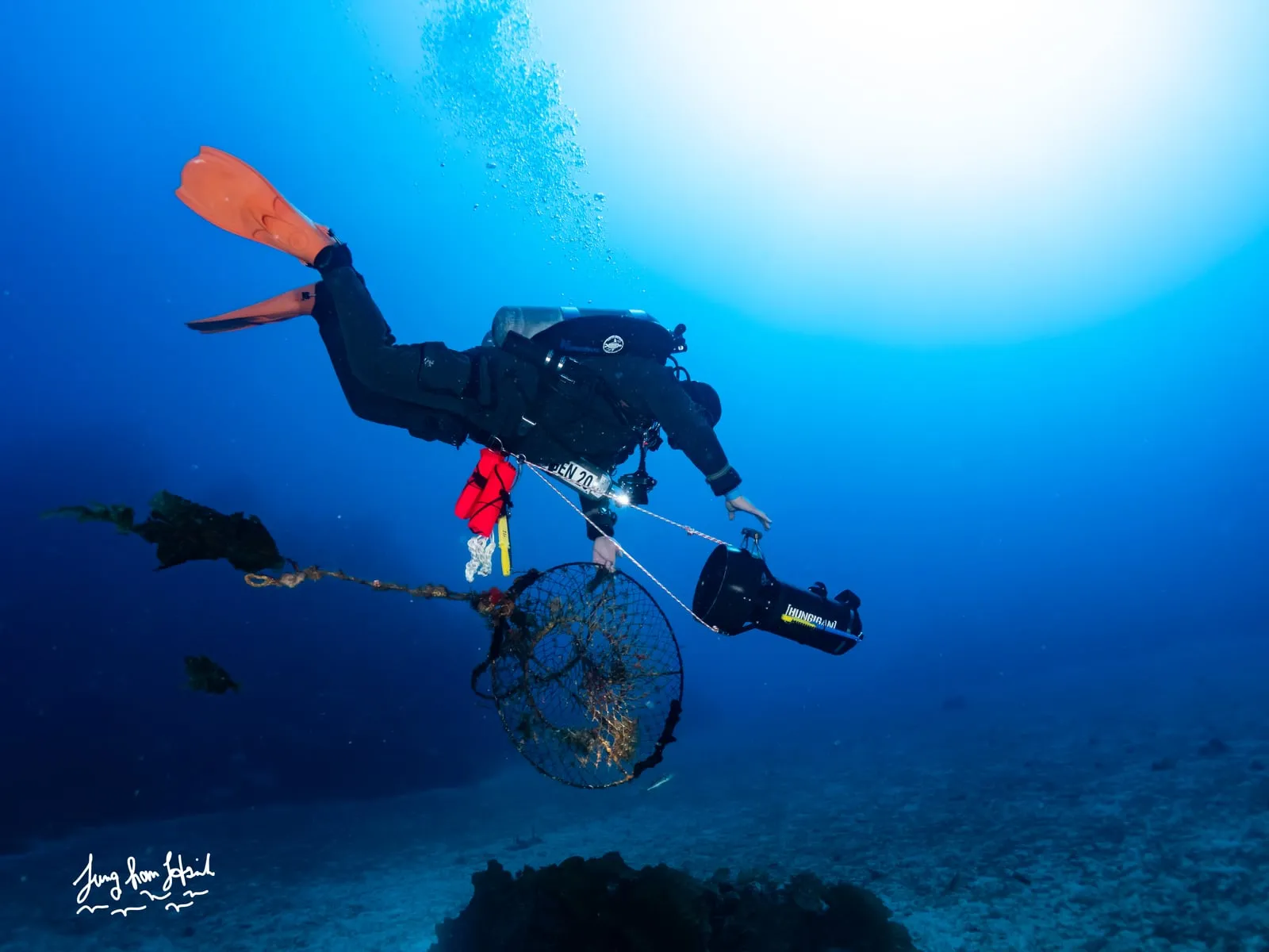 A diver rigs a lost hoop net for the lift to the surface.